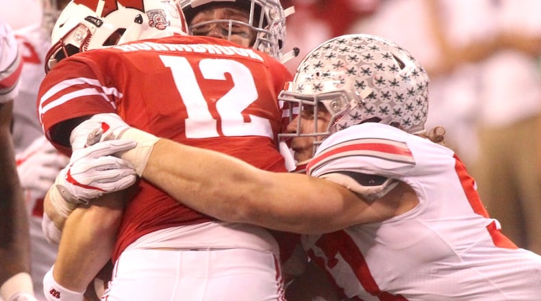 Ohio State’s Nick Bosa tackles Wisconsin’s Alex Hornibrook on Dec. 2, 2017, at Lucas Oil Stadium in Indianapolis. David Jablonski/Staff