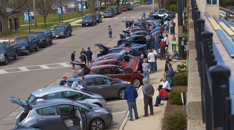 As Oakwood passed an ordinance recently to add $5 to the vehicle tax to pay for street work, Drive Electric Dayton made a pitch to city officials to promote the use of electric vehicles. Pictured is the Earth Day ride in Oakwood.