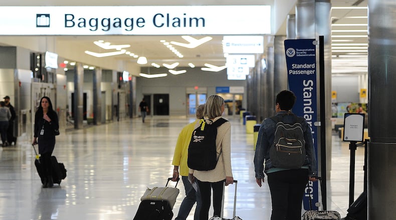 Travelers at the Dayton International Airport. MARSHALL GORBY\STAFF
