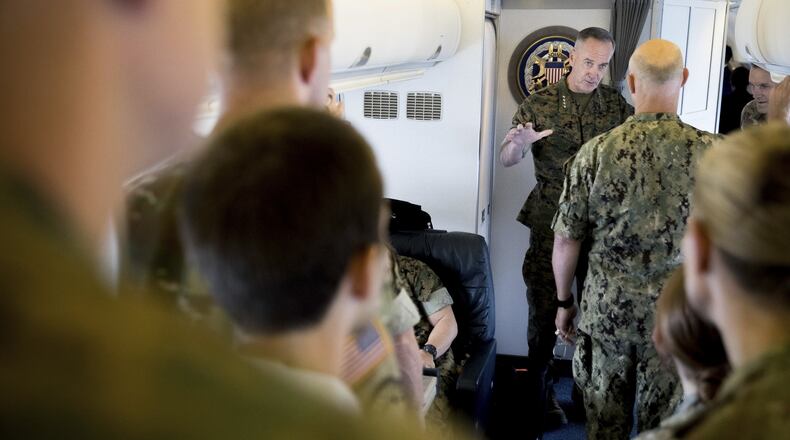 Joint Chiefs Chairman Gen. Joseph Dunford speaks to members of his staff aboard his plane as it departs Fort Greely, Alaska, Saturday, Aug. 19, 2017, to travel to Andrews Air Force Base, Md. President Donald Trump is “studying and considering his options” for a new approach to Afghanistan and the broader South Asia region, the White House said Friday. Gen. Joseph Votel, the Central Command chief who is responsible for U.S. military operations in the greater Middle East, including Afghanistan said that Defense Secretary Jim Mattis and Dunford represent him in the White House-led Afghanistan strategy review. (AP Photo/Andrew Harnik)