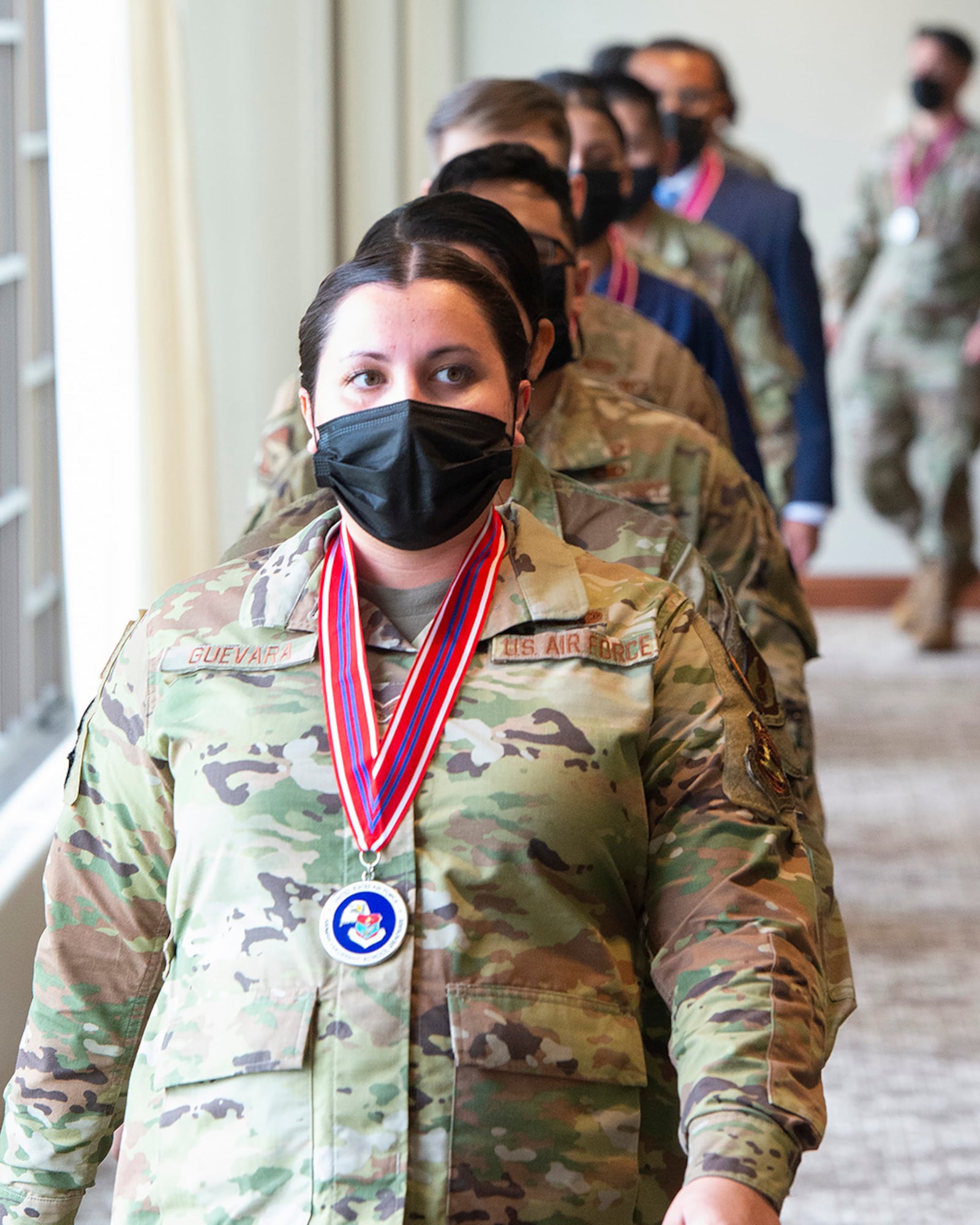 Senior Airman Diamond Guevara, National Air and Space Intelligence Center, leads Airman Leadership School Class 21-D into their graduation ceremony May 6 at the Wright-Patterson Club. The class of 36 active-duty Airmen, civilians and a Coast Guard petty officer received their certificates following the end of their class. U.S. AIR FORCE PHOTO/R.J. ORIEZ
