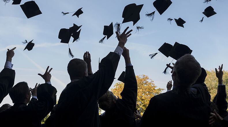 LEIPZIG, GERMANY - AUGUST 30: Graduates in gown and caps celebrate their graduation at the HHL Leipzig Graduate School of Management on August 30, 2014 in Leipzig, Germany. A total of 167 students in various Masters programs of business management graduated today, including the regular MBA program, whose students are 80% from foreign countries, while the more advanced graduate programs have a higher percentage of German-born students. (Photo by Jens Schlueter/Getty Images)