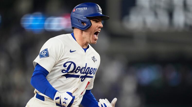 Los Angeles Dodgers' Freddie Freeman celebrates his walk off home run against the Toronto Blue Jays during the 18th inning in Game 3 of baseball's World Series, Monday, Oct. 27, 2025, in Los Angeles. (AP Photo/Brynn Anderson)