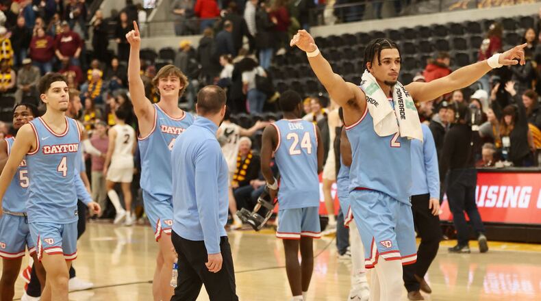 Dayton's Toumani Camara celebrates after a victory against Loyola Chicago on Friday, Feb. 17, 2023, at Gentile Arena in Chicago, Ill. David Jablonski/Staff