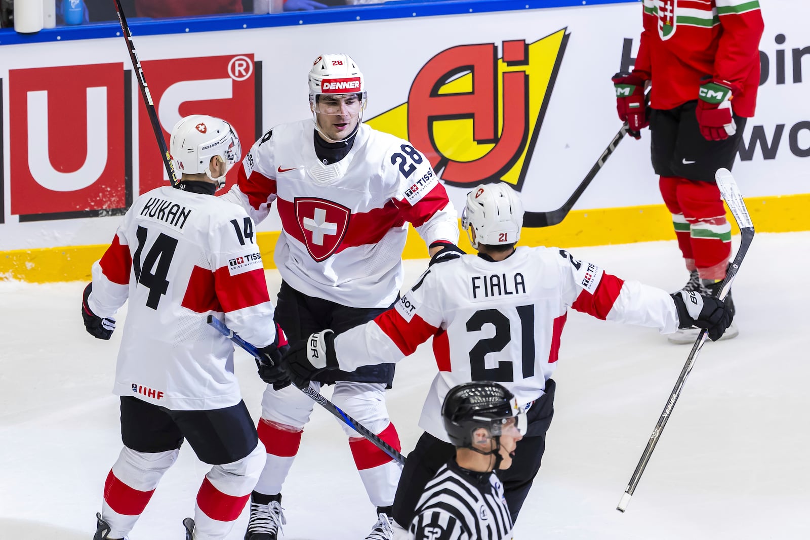 Switzerland's forward Timo Meier, center, celebrates his goal with his teammates Dean Kukan, left and Kevin Fiala, center right after scoring, during the IIHF 2025 World Championship preliminary round group B game between Hungary and Switzerland, at the Jyske Bank Boxen, in Herning, Denmark, Sunday, May 18, 2025. (Salvatore Di Nolfi/Keystone via AP)