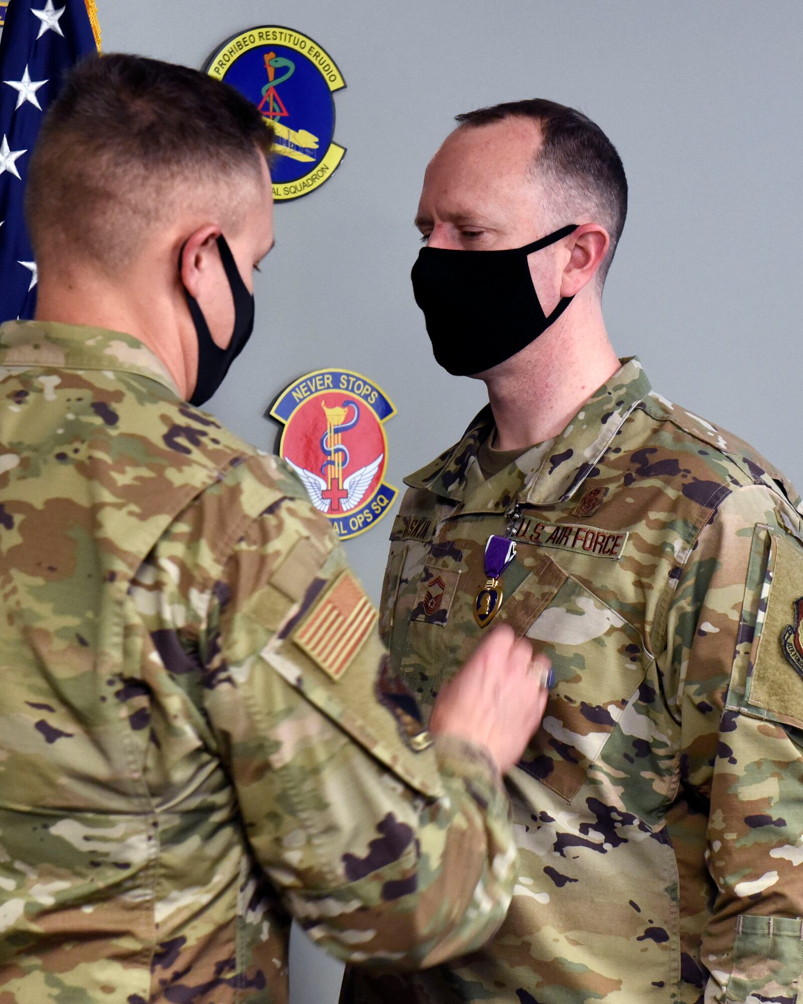 Air Force Senior Master Sgt. Bruce D. Haskin, a superintendent for the 88th Air Base Wing Medical Support Squadron, receives a Purple Heart from Col. Christian Lyons, 88th Medical Group commander at Wright-Patterson Air Force Base, Ohio on Feb. 4, 2021. Haskin sustained a traumatic brain injury and severe tinnitus when a vehicle-borne improvised explosive device was detonated during an attack at Bagram Air Base, Afghanistan, on Dec. 11, 2019. (U.S. Air Force photo by Ty Greenlees)