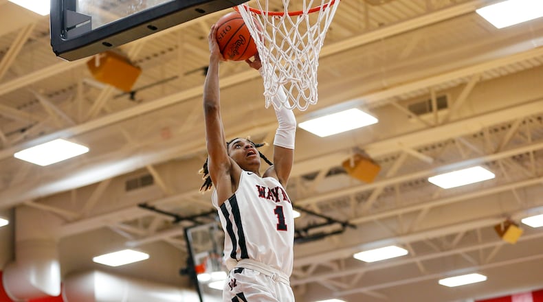 Wayne High School junior Lawrent Rice dunks the ball during a game against Springfield on Tuesday night in Huber Heights. The Warriors won 82-65. CONTRIBUTED PHOTO BY MICHAEL COOPER