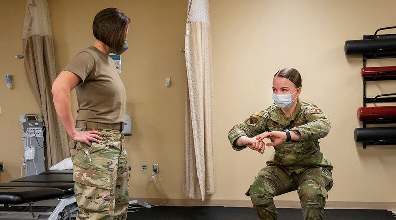 Lt. Col. Erin Sturgell, commander of the 88th Operational Medical Readiness Squadron’s Physical Medicine Flight, watches as Airman 1st Class Leah Fitzke, physical medicine technician, demonstrates a balance exercise Jan. 25 at Wright-Patterson Medical Center. Physical therapy is part of the Biomedical Sciences Corps, which is made up of multiple specialties including the pharmacy, biomedical lab, public health, physical/occupational therapy, optometry, bioenvironmental, clinical social work and nutritional medicine. U.S. AIR FORCE PHOTO/R.J. ORIEZ