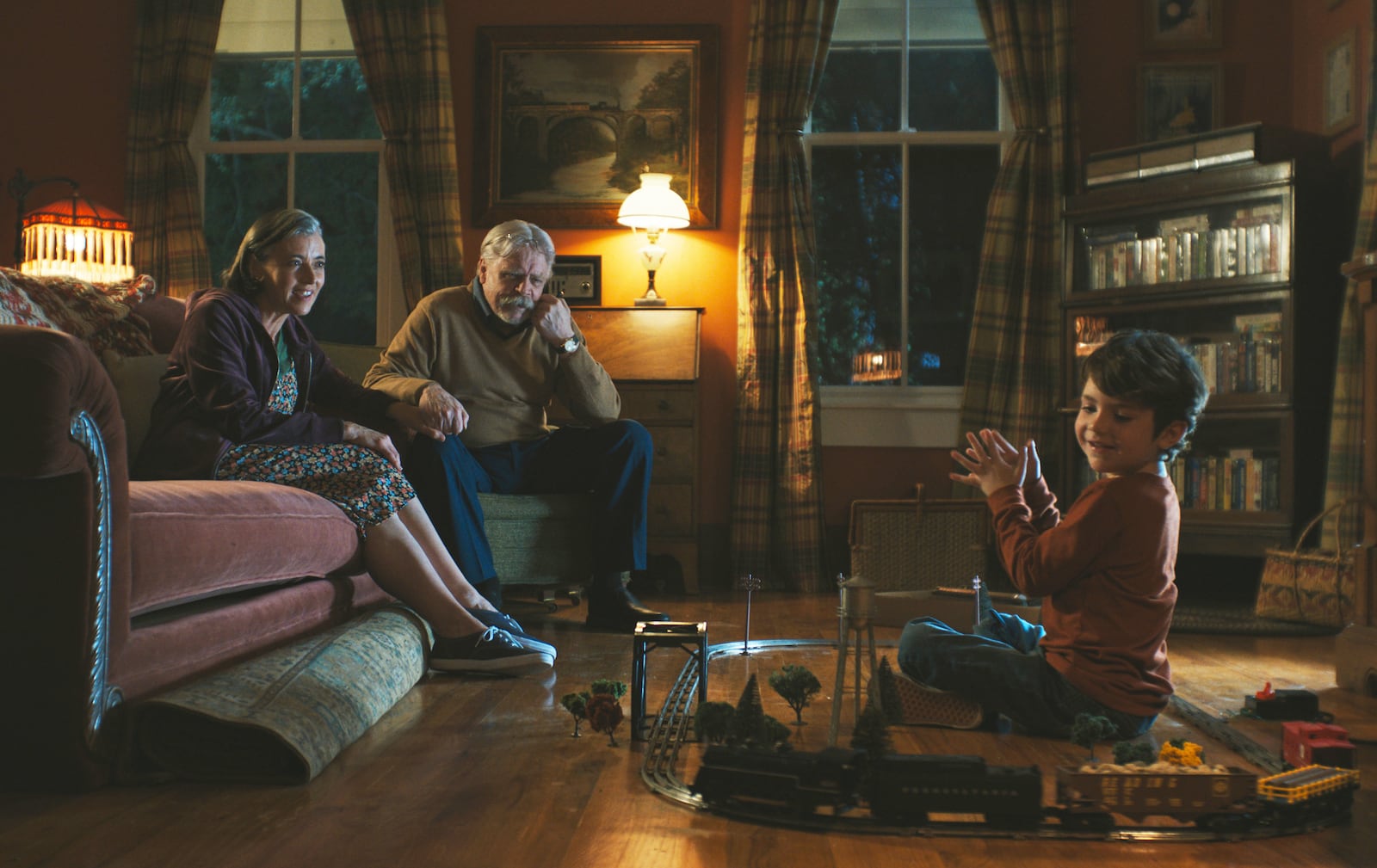 This image released by Neon shows Mia Sara, from left, Mark Hamill, and Cody Flanagan in a scene from "The Life of Chuck." (Neon via AP)