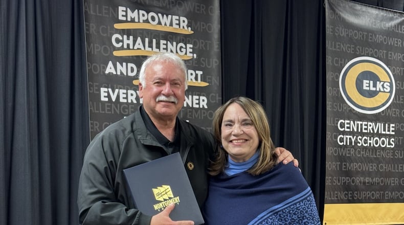 Centerville School District Board of Education member Dr. David Roer is presented with proclamations from the Montgomery County Board of County Commissioners by Commissioner Carolyn Rice at the school board's meeting Monday, Dec. 15, 2025. Roer, who has 32 years of experience on the school board, opted to not run for re-election last month. CONTRIBUTED