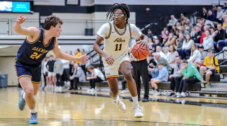 Alter High School's Naceive Fenton drives past Oakwood's Owen Hoersting during their Division IV regional semifinal game on Tuesday, March 4 at Lakota East High School. MICHAEL COOPER/CONTRIBUTED
