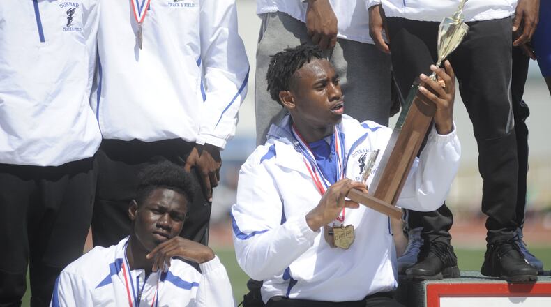 Dunbar’s Jalani Allen admires the boys state championship trophy during the D-II state track and field meet at OSU’s Jesse Owens Memorial Stadium in Columbus on Saturday, June 3, 2017. MARC PENDLETON / STAFF