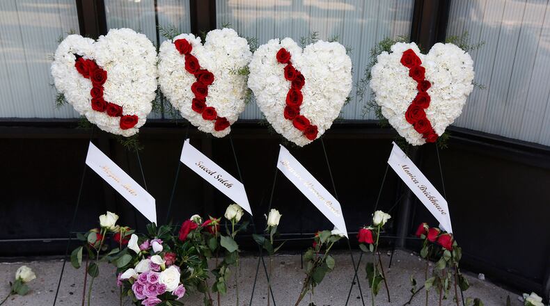 Memorials to the Dayton shooting victims and dozens of media workers filled the sidewalks of the Oregon District on Monday morning in the wake of ten people being killed, including the shooter, and more than two dozen injured at 1:00 A.M. on Sunday morning.  TY GREENLEES / STAFF
