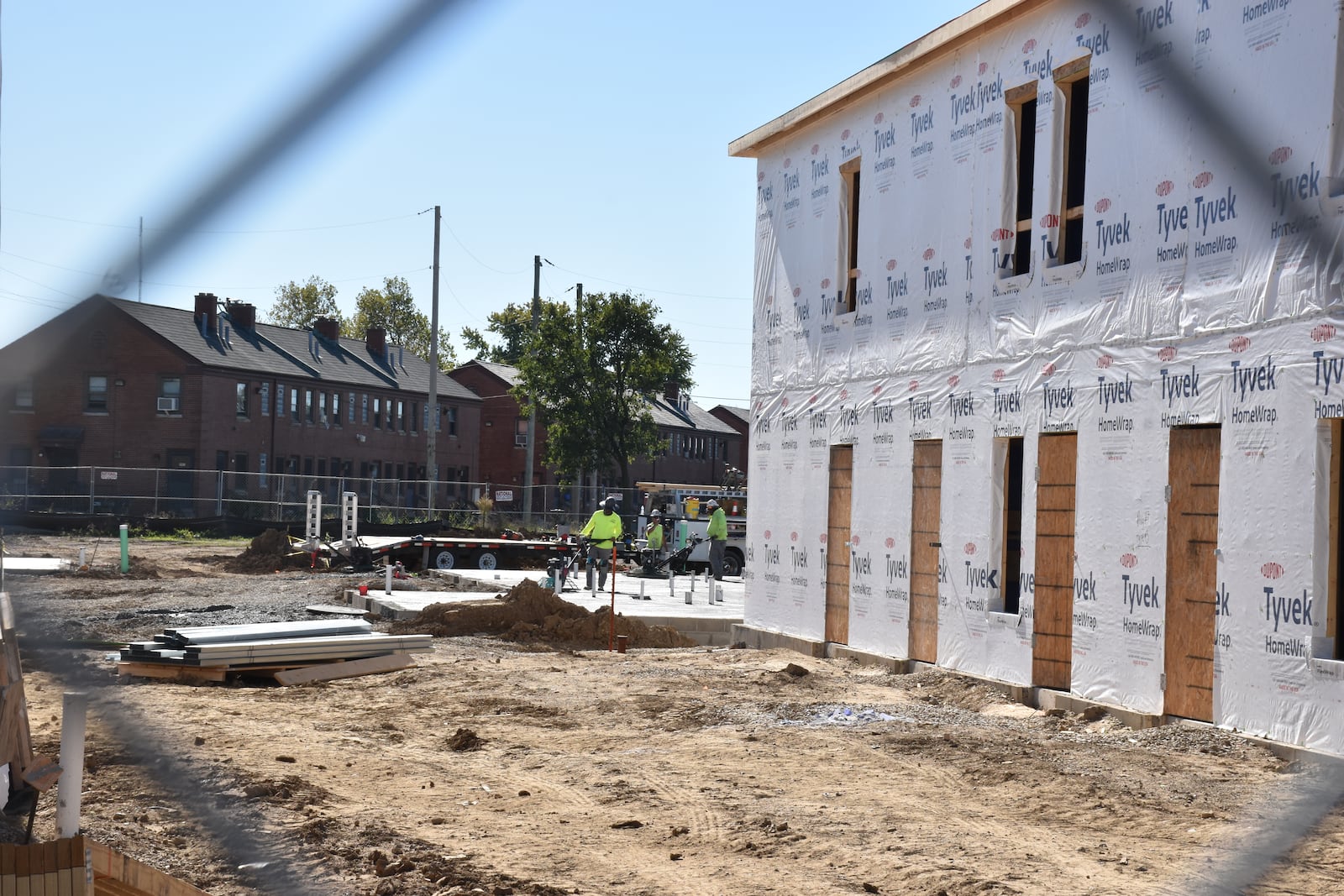 Construction crews work to build new apartments at the DeSoto Bass Courts in West Dayton. CORNELIUS FROLIK / STAFF
