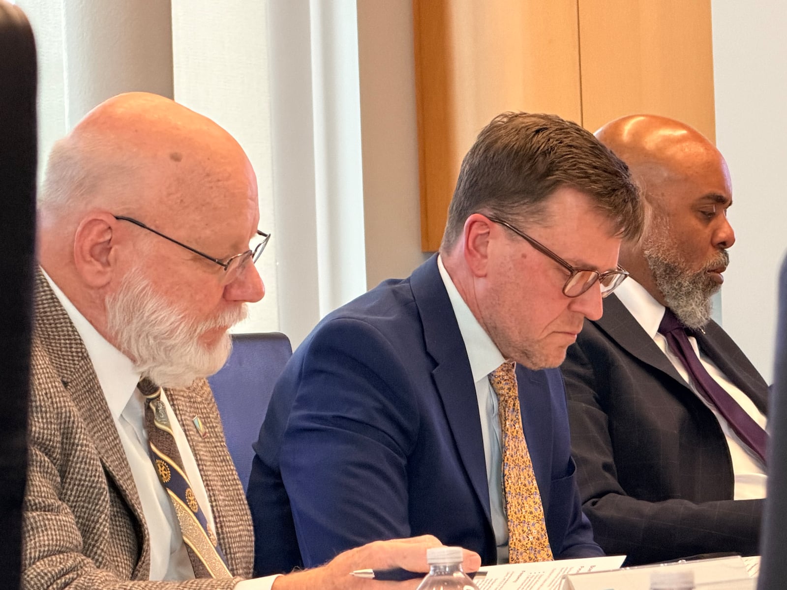 Dayton Metro Library Executive Director Jeffrey Trzeciak (center) shuffles through reports at the March 18, 2026 board meeting for the library's trustees. SYDNEY DAWES/STAFF