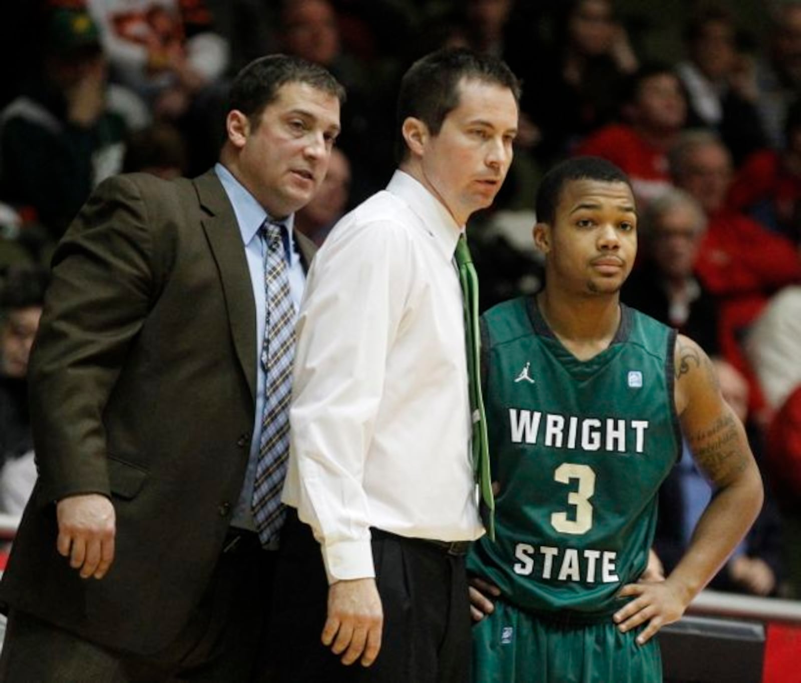 Wright State coaches Scott Woods and Billy Donlon talk with guard Reggie Arceneaux on Sunday, Dec. 15, 2013, at Millett Hall in Oxford.