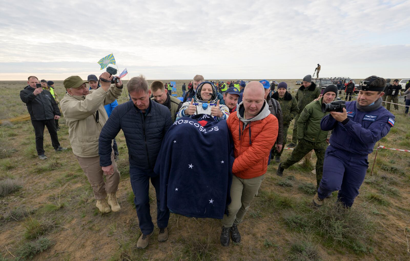 Roscosmos cosmonaut Ivan Vagner gestures as he is carried to a medical tent shortly after landing in a Soyuz MS-26 spacecraft with fellow cosmonaut Alexey Ovchinin and NASA astronaut Don Pettit near the town of Zhezkazgan, Kazakhstan, Sunday, April 20, 2025. (Bill Ingalls/NASA via AP)