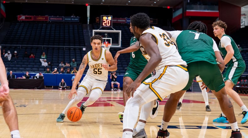 Wright State University guard Michael Cooper shoots dribbles past an Ohio University defender during their preseason game at UD Arena on Monday, Oct. 20 at UD Arena. The Raiders beat the Bobcats 63-57. WRIGHT STATE ATHLETICS / CONTRIBUTED PHOTO
