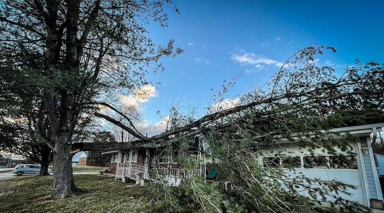 Part of a tree fell on a house on Kutcher Street in Miamisburg on Thursday, Jan. 19, 2023. JIM NOELER/STAFF