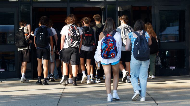 Students arrive Wednesday, Aug. 14, 2024 for the first day of school at Beavercreek High School. MARSHALL GORBY\STAFF
