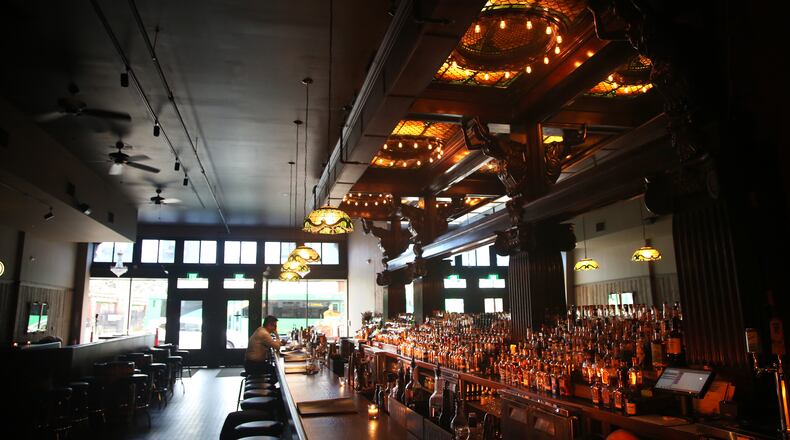 Daytonâs Century Bar has reopened in the three-story former Dayton Power and Light building, 18 S. Jefferson St. The historic cherry wood bar, the centerpiece of the original Century Bar, has been restored and installed in the new expanded space. Century Bar is co-owned by Diane Spitzig and Joseph Head. LISA POWELL / STAFF