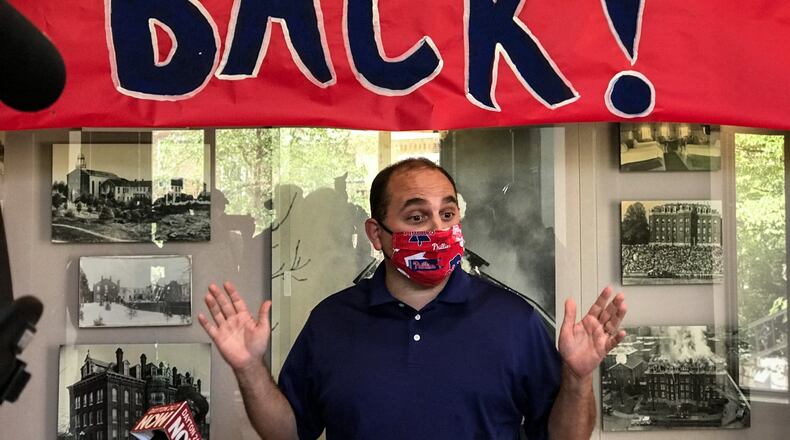 Professor and Chair of the Department of Communications at the University of Dayton talks to the media about the importance of the school opening to student this fall. JIM NOELKER/STAFF