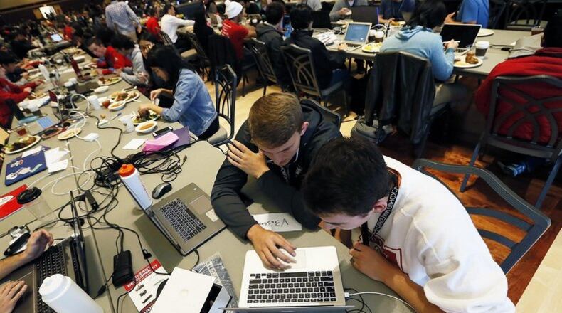 Ohio State sophomores Cory Miller (left) and Danny Freyschlag research ideas Saturday during the annual hackathon on campus. THE COLUMBUS DISPATCH
