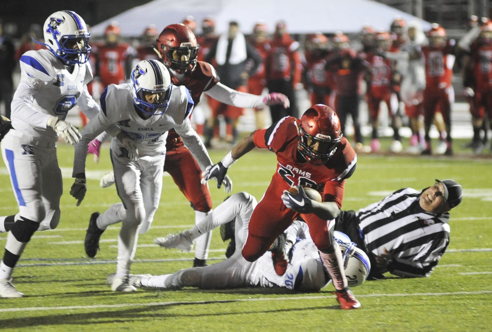 A referee is taken out on Trotwood’s Dae’Vontay Latimer (with ball) TD run. Xenia defeated host Trotwood-Madison 29-28 in double OT in a Week 9 high school football game on Friday, Oct. 19, 2018. MARC PENDLETON / STAFF