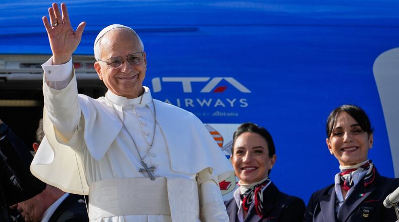 Pope Leo XIV waves as he boards a flight back to the Vatican after his visit to Lebanon at Beirut International Airport in Beirut, Lebanon, Tuesday, Dec. 2, 2025. (AP Photo/Hussein Malla)