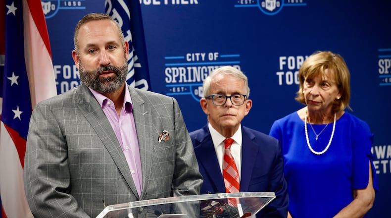 Springfield schools Superintendent Bob Hill, with Ohio Governor Mike DeWine, and his wife Fran, answer questions at a press conference Tuesday, September 17, 2024 at City Hall in Springfield. MARSHALL GORBY \STAFF