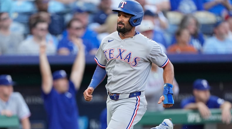 FILE - Texas Rangers' Marcus Semien runs home to score on an RBI single hit by Jonah Heim during the second inning of a baseball game against the Kansas City Royals, Monday, Aug. 18, 2025, in Kansas City, Mo. (AP Photo/Charlie Riedel, File)