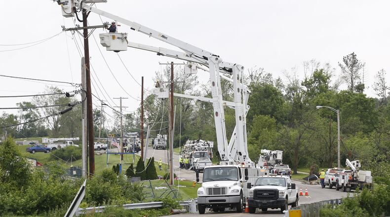 Linemen began the long process of repairing downed power lines along Salem Bend Drive in Trotwood on Wednesday. A tornado took out power to tens of thousands residents in the region on Monday night. TY GREENLEES / STAFF