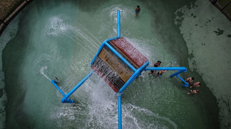 Kids and adults enjoyed the splash pad at Island MetroPark Tuesday June 18, 2024. This week the Dayton area is expecting near100 degree temperatures all week. JIM NOELKER/STAFF