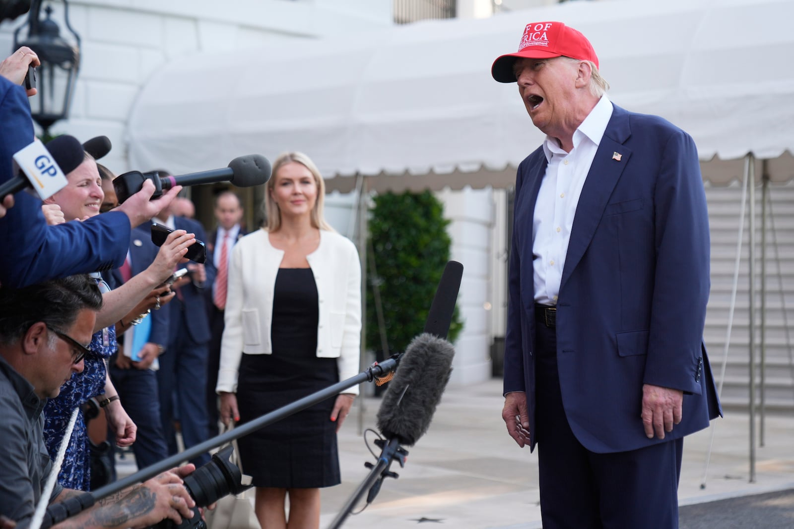 President Donald Trump speaks to the media before walking across the South Lawn of the White House to board Marine One en route to Joint Base Andrews, Md., and on to Florida, Tuesday, July 1, 2025, in Washington. (AP Photo/Mark Schiefelbein)