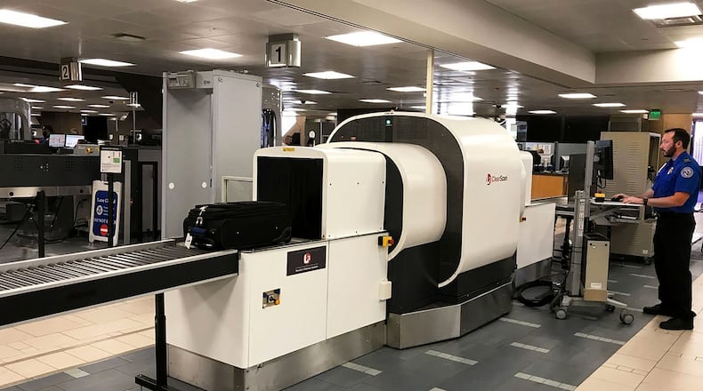 An agent uses a new computed tomography scanner at Phoenix Sky Harbor International Airport. The Transportation Security Administration has announced it plans to test 15 new CT scanners in the next few months. (TSA/TNS)