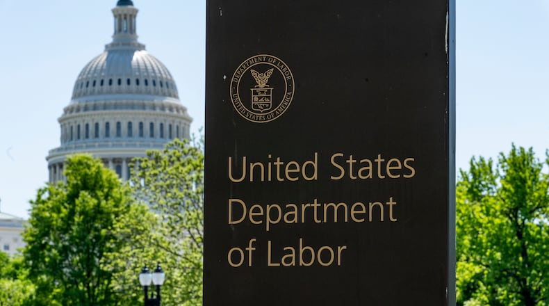 FILE - In this May 7, 2020, file photo, the entrance to the Labor Department is seen near the Capitol in Washington. (AP Photo/J. Scott Applewhite, File)