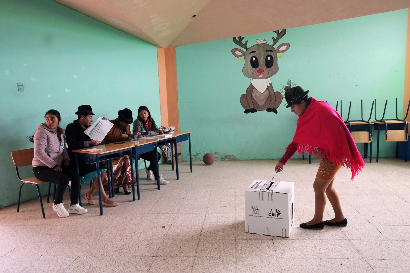 A voter casts her ballot in the presidential election runoff in Pujili, Ecuador, Sunday, April 13, 2025. (AP Photo/Dolores Ochoa)