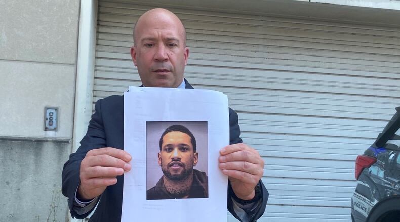 Dayton Police Lt. Jason Hall holds up the image of the person of interest, identified as 20-year-old Shamarr Bodine, in the Monday, July 5, 2021, shooting death of a 13-year-old girl on Kipling Drive in Dayton. EILEEN McCLORY / STAFF