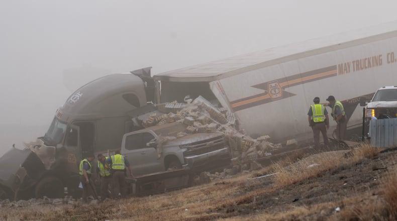 Emergency personnel work the scene of a crash involving 30-plus vehicles including six semi trucks on Interstate 25 south of Pueblo, Colo., on Tuesday, Feb. 17, 2026. (Christian Murdock/The Gazette via AP)