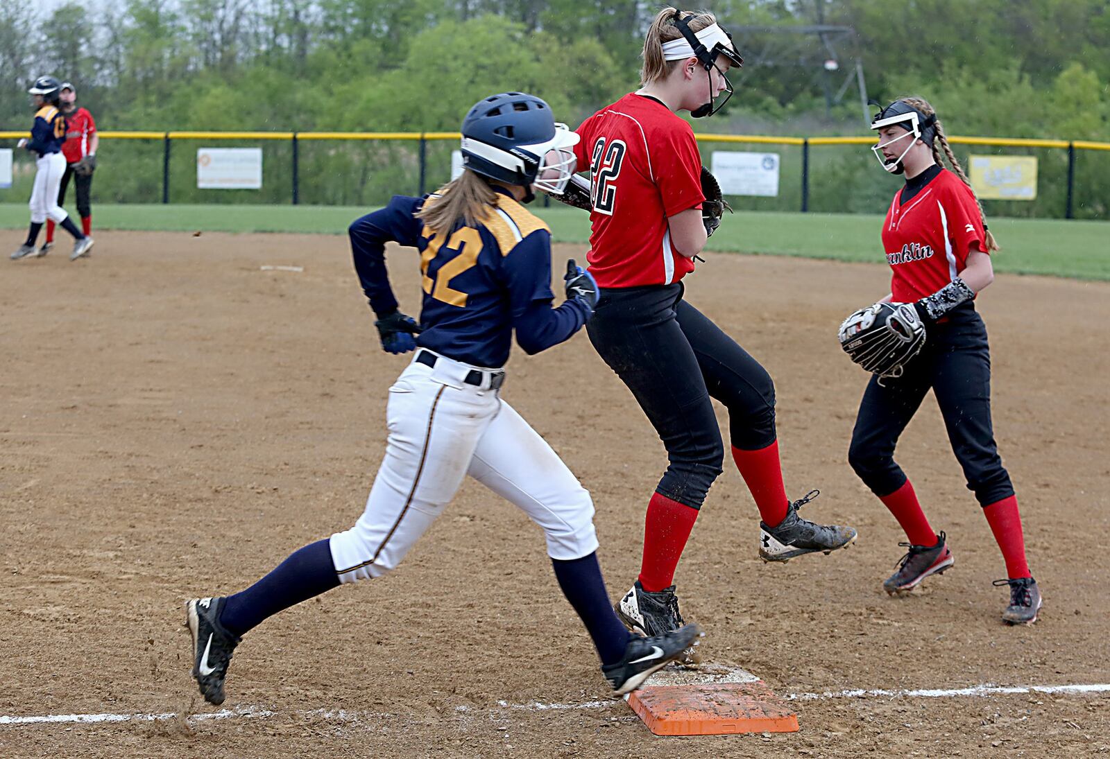Franklin first baseman Brooke Stover beats Monroe’s Sam Schwab to the bag for an out during Wednesday’s game at Monroe. CONTRIBUTED PHOTO BY E.L. HUBBARD