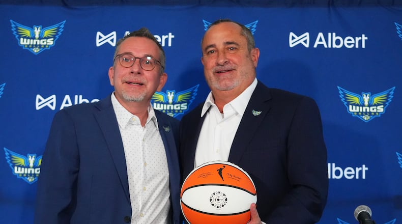 Dallas Wings general manager Curt Miller, left, poses for photographers with Jose Fernandez, right, during a news conference introducing Fernandez as the WNBA basketball team's new head coach, Thursday, Nov. 6, 2025, in Dallas. (AP Photo/Julio Cortez)