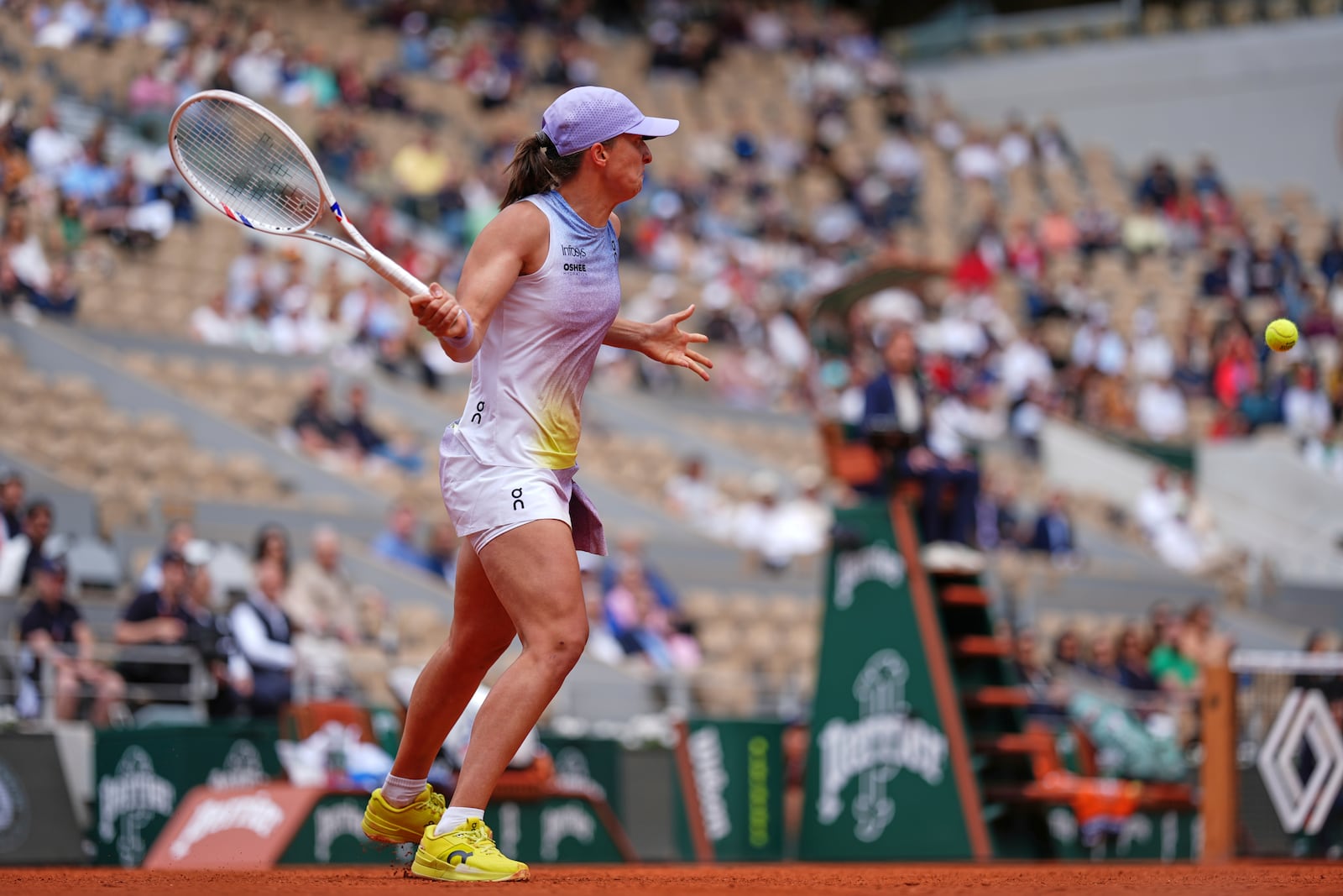 Poland's Iga Swiatek returns the ball to Slovakia's Rebecca Sramkova during their first round match of the French Tennis Open, at the Roland-Garros stadium, in Paris, Monday, May 26, 2025. (AP Photo/Lindsey Wasson)