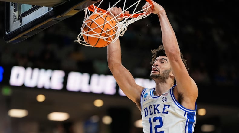 Duke forward Cameron Boozer dunks against TCU during the second half in the second round of the NCAA college basketball tournament, Saturday, March 21, 2026, in Greenville, S.C. (AP Photo/Chris Carlson)