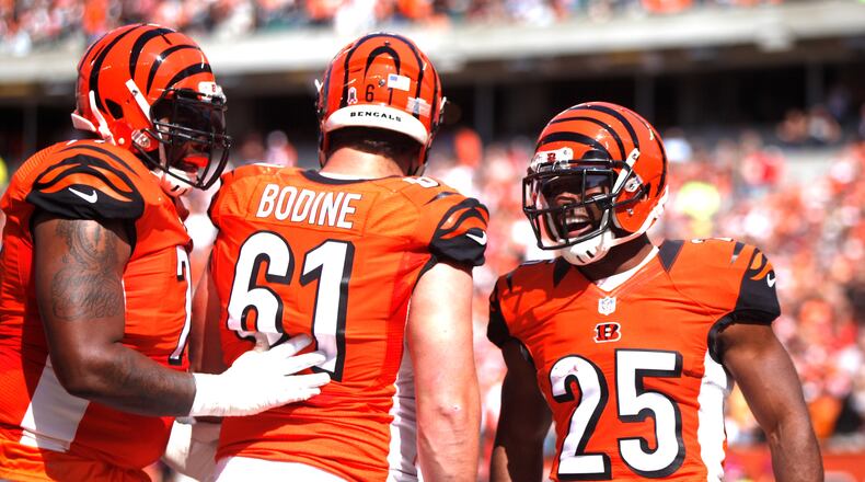 Bengals running back Giovani Bernard, right, celebrates a touchdown with center Russell Bodine (61) and Andre Smith against the Chiefs on Sunday, Oct. 4, 2015, at Paul Brown Stadium in Cincinnati. David Jablonski/Staff