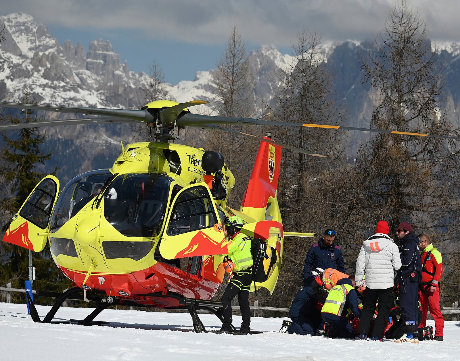 Italy's Federica Brignone is assisted before being flown by helicopter to an hospital, after she broke multiple bones in her left leg during a giant slalom crash at the Italian championships in the Lusia ski area, in Val di Fassa, Italy, Thursday, April 3, 2025. (AP Photo/Elvis Piazzi)