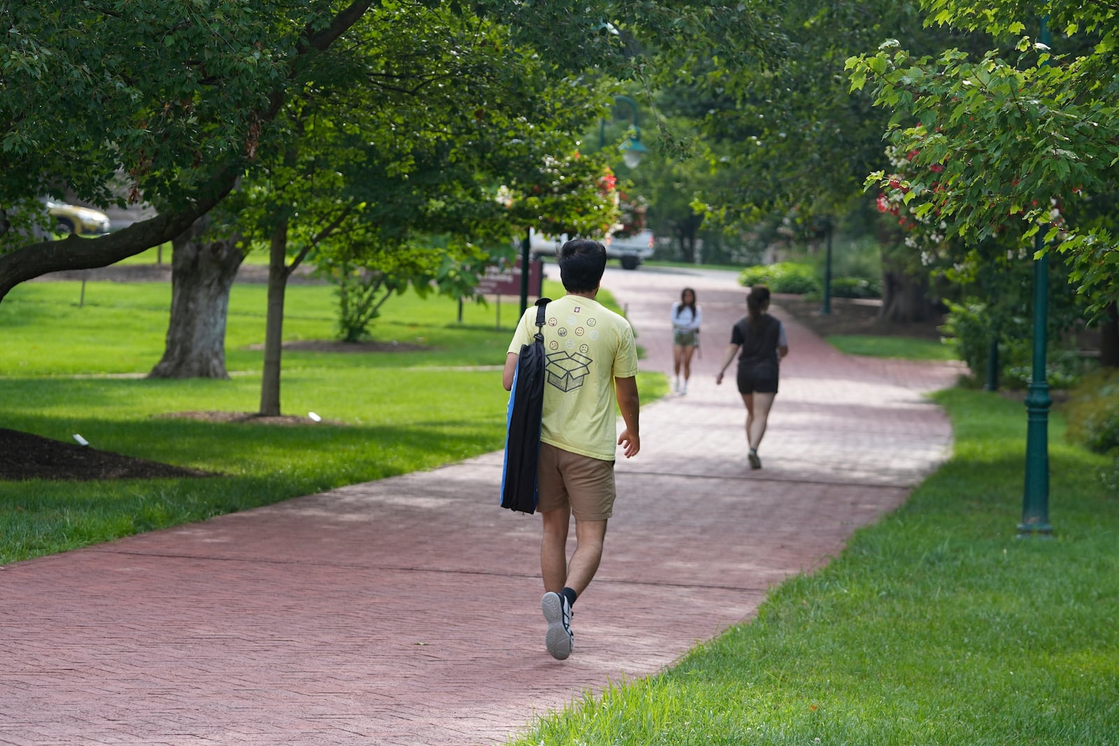 Students walk on the campus of Indiana University, Thursday, July 17, 2025, in Bloomington, Ind. (AP Photo/Darron Cummings)