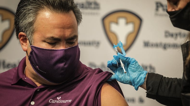 Erhardt Preitauer, president and chief executive of CareSource of Dayton, gets his second COVID-19 vaccine at the Dayton Convention Convention Center on Thursday, April 8, 2021. The company is encouraging employees to get vaccinated.