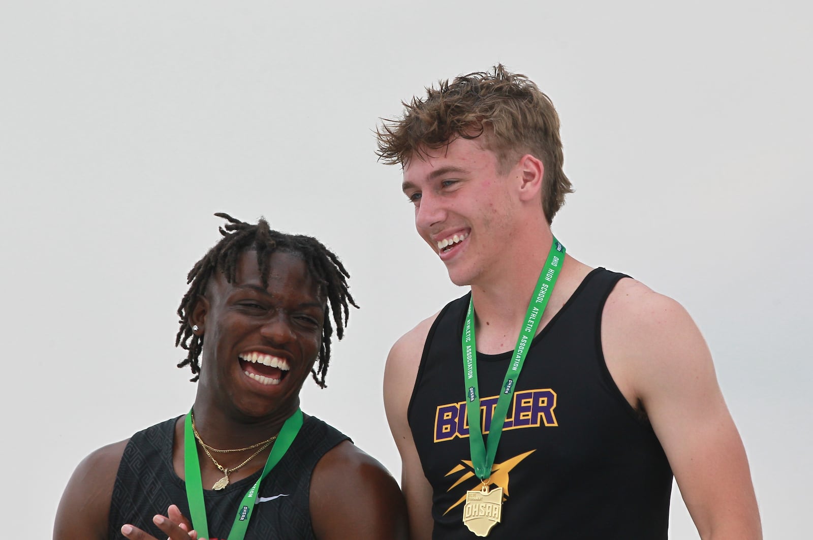 Jamier Averette-Brown of Wayne (left) and Butler's Jordan Gross share a laugh after the 200-meter final on Saturday at Ohio State's Jesse Owens Memorial Stadium in Columbus. MARCUS HARTMAN / STAFF PHOTO
