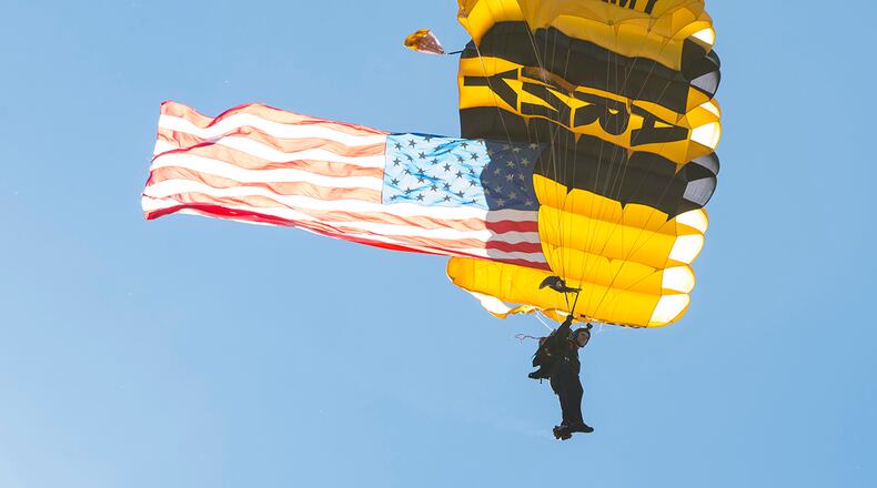 A member of the Golden Knights U.S. Army Parachute Team prepares for landing while flying the American flag at the Dayton Air Show on July 30 this year. U.S. AIR FORCE PHOTO/JAIMA FOGG