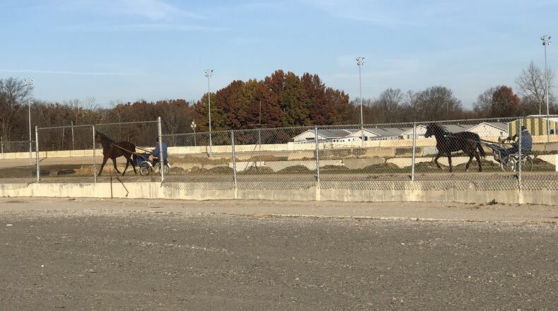 Horses warm up on the track at the Warren County Fairgrounds. Warren County is close to moving forward with construction of an event center replacing grandstands demolished after harness racing moved out to the Miami Valley Gaming & Racing outside of Lebanon. Officials hope the new facilities are in place before next year’s fair. STAFF/LAWRENCE BUDD